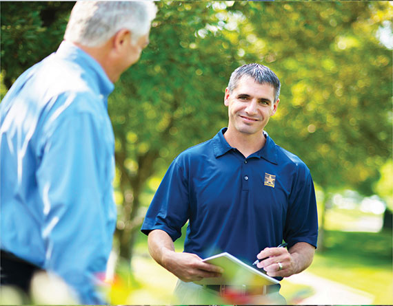 U.S. Lawns staff meeting with a Veteran