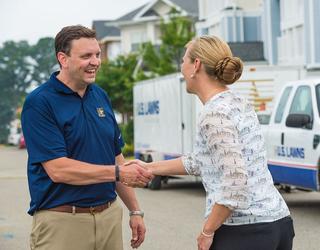 U.S. Lawns franchisee shaking hands with a client U.S. Lawns franchisee shaking hands with a client